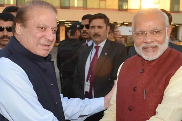 In Pakistan , Prime Minister Nawaz Sharif (left) greets Narendra Modi of India. Press Information Dept. via AP