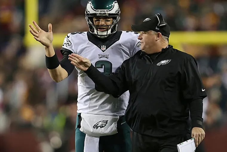Eagles' head coach Chip Kelly talks with Mark Sanchez, left, during the 2nd quarter. Philadelphia Eagles play the Washington Redskins at FedEx Field in Landover, MD on December 20,  2014.  (David Maialetti/Staff Photographer)