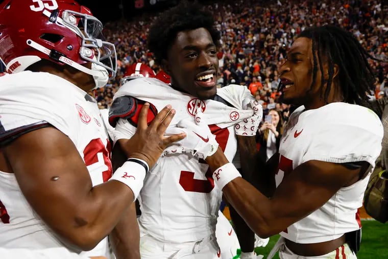 Alabama defensive back Terrion Arnold (center) celebrates with linebackers Jeremiah Alexander (left) and Trezmen Marshall after an interception to end their game against Auburn this past season.