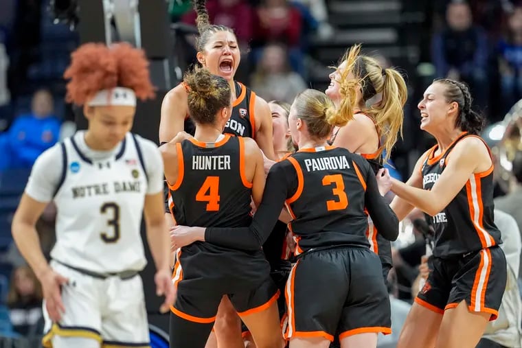 Oregon State players celebrate as Hannah Higaldo laments the Beavers' win over Notre Dame.