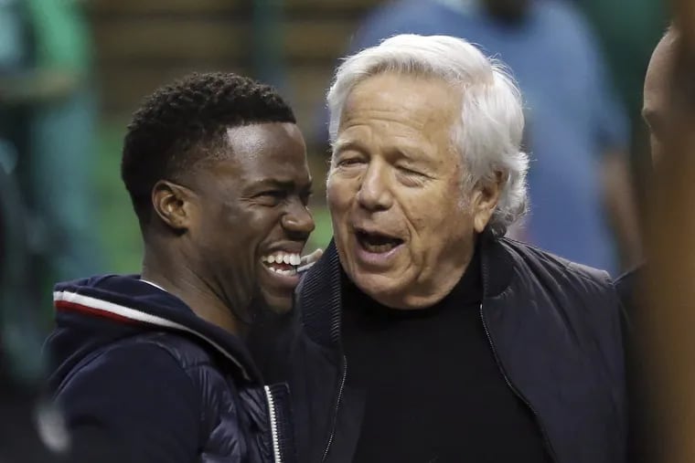 Comedian Kevin Hart, left, chats with New England Patriots football team owner Robert Kraft during halftime of Game 2 of an NBA basketball second-round playoff series against the Philadelphia 76ers, Thursday, May 3, 2018, in Boston.