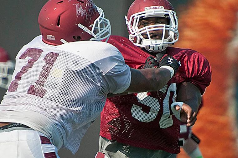 Temple defensive lineman Praise Martin-Oguike battles with a teammate. (Ron Tarver/Staff Photographer)