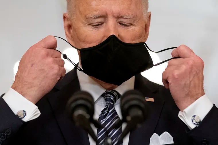 President Joe Biden takes off his mask to speak about the COVID-19 pandemic during a prime-time address from the East Room of the White House, on March 11, 2021, in Washington.