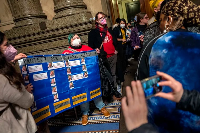 Domestic workers display their tally of members of Philadelphia City Council who have signed up to support them in the hallway at City Hall on Thursday.