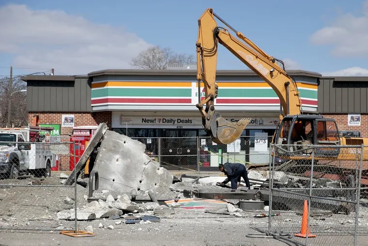 An investigator works at the scene after a gas pump exploded at a 7-Eleven in Philadelphia on March 12, 2019.