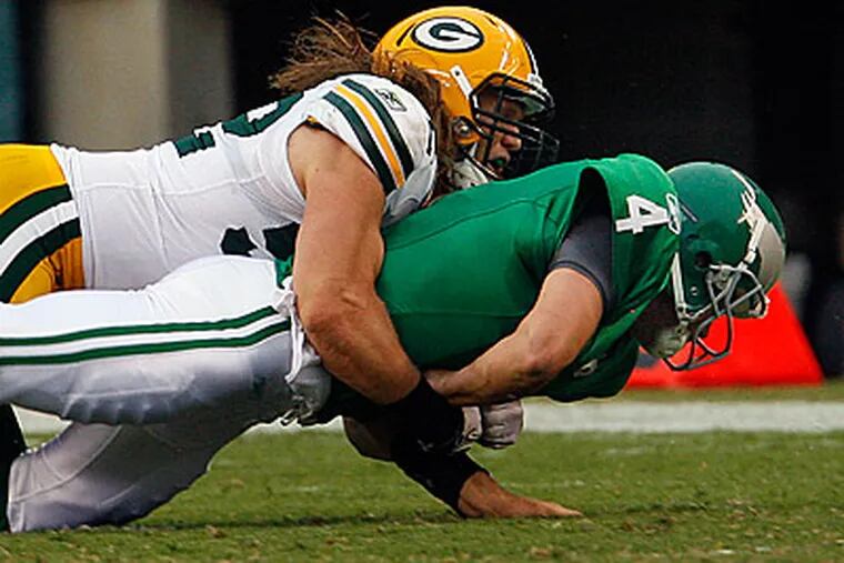 Kevin Kolb is sacked by Clay Matthews. Kolb did not return in the second half because of a concussion. (Ron Cortes/Staff Photograher)