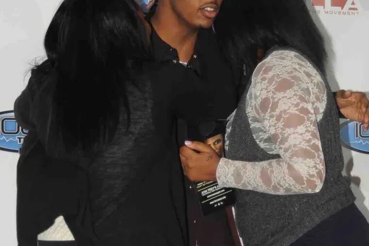 Singer Trey Songz gets a warm greeting from two fans at Sigma Sound Studios in Philadelphia. WPHI-FM (The Beat) sponsored the promotion. (See "The circuit.")