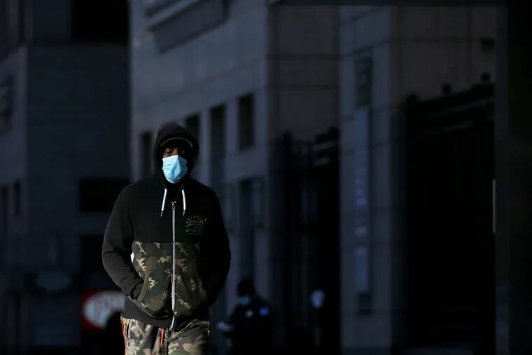 A pedestrian wears a face mask to prevent the spread of the coronavirus in Center City Philadelphia on Tuesday.