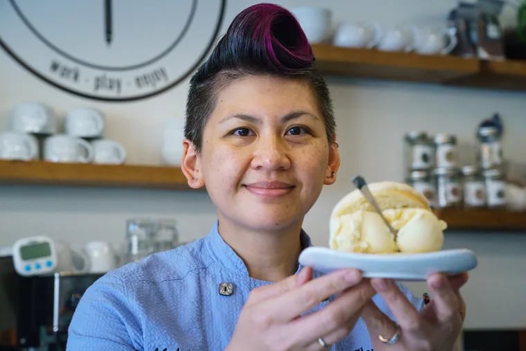 Melanie Diamond-Manlusoc, chef and co-owner of Flow State CoffeeBar, shown cooking at her cafe, in Philadelphia, July 17, 2019. The dessert she is holding is an example of the type of Fillipino desserts served at Flow State CoffeeBar, this dessert is a reference /combination to ensaymada which is a sweet brioche bunn slathered with butter, sugar and cheese, and the Spanish Concha, in the middle of this bun is home made honey gelato, but for Fridays dessert offering the gelato will be sweet corn gelato, a flavor frequently found in Filipino desserts, in Philadelphia, July 17, 2019.
