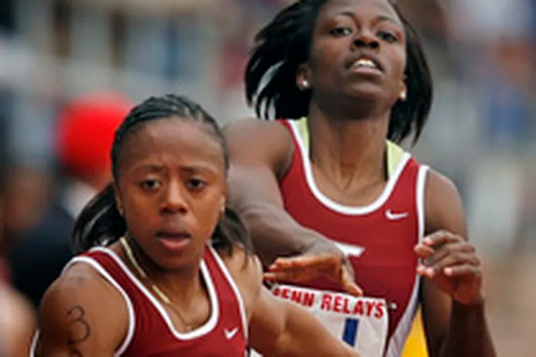 Virginia Tech&#0039;s Asia Washington takes the baton from Britni Spruill in a heat of the 4x400 relay. Competition is giving the Hokies a way to deal with the recent shootings on campus.
