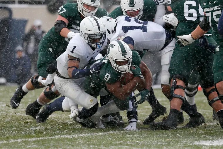 Michigan State's Kenneth Walker III (9) rushes for a touchdown against Penn State's Jaquan Brisker (1) during the first quarter, Saturday, Nov. 27, 2021, in East Lansing, Mich.