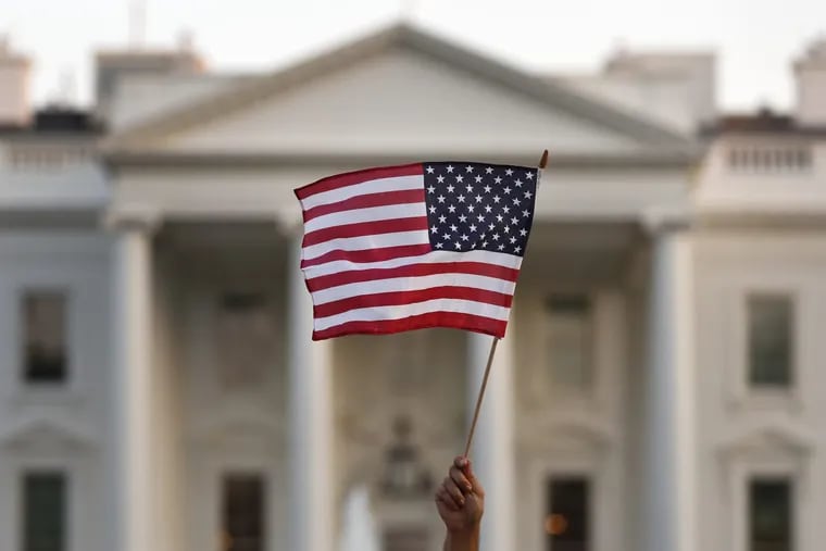 A protester waves the U.S. flag during a Sept. 4 rally in front of the White House.