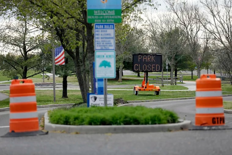 A 'PARK CLOSED' sign on Thursday alerts people that the Gloucester Township Community Park in Camden County is closed.