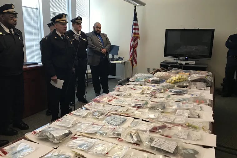 Philadelphia Police Deputy Commissioner Dennis Wilson speaks about the drugs and guns confiscated during a three-day anti-crime initiative in the Kensington area last week. At far right in photo is Kurt August, program manager for the city's Police-Assisted Diversion program. In between them is Police Inspector Joseph Fredericksdorf of the Narcotics Bureau.