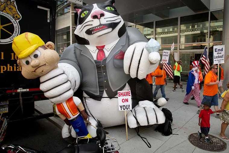 updated caption 
Members of the Metropolitan Regional Council of Carpenters hold a protest rally outside the Pennsylvania Convention Center protest at the entrance at N. Broad St. at Arch on Friday morning July 11, 2014.. The union's fat cat doll symbolizes “the man” holding them down, locking them out and refusing them work.  The Carpenters Local feel unfairly locked out of the PA Convention Center. ( ALEJANDRO A. ALVAREZ / STAFF PHOTOGRAPHER )