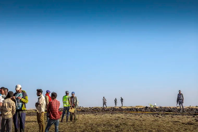 Rescuers search at the scene of an Ethiopian Airlines flight that crashed shortly after takeoff at Hejere near Bishoftu, or Debre Zeit, some 50 kilometers (31 miles) south of Addis Ababa, in Ethiopia Sunday, March 10, 2019. The Ethiopian Airlines flight crashed shortly after takeoff from Ethiopia's capital on Sunday morning, killing all 157 on board, authorities said, as grieving families rushed to airports in Addis Ababa and the destination, Nairobi.