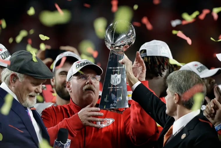 Kansas City Chiefs chairman Clark Hunt (right) hands the Lombardi Trophy to Andy Reid.