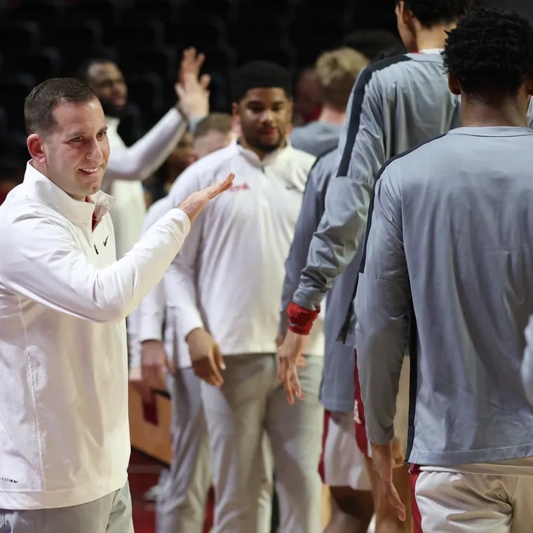 Coach Adam Fisher of Temple high-fiving the players before the team played East Carolina at the Liacouras Center on Jan. 10, 2024.