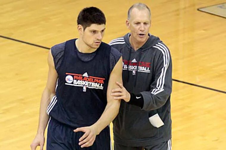 Sixers coach Doug Collins instructs rookie center Nikola Vucevic during practice on Friday. (David Swanson/Staff Photographer)