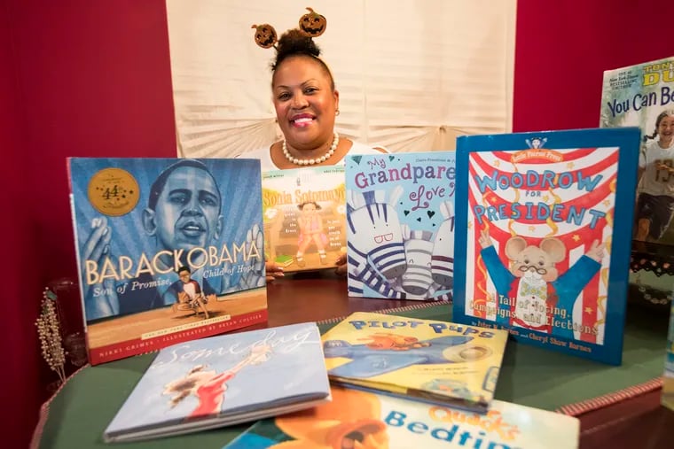 Sherry Knight, Principal of the Captain James Lawrence Elementary School in Burlington City, wanted to help her students improve their reading skills. So she reads to them herself - bedtime stories via Facebook. Knight has slowly gained an audience since she started the project at the end of the 2018-19 school year.  She is shown with a selection of book donated by Scholastic Books on Oct. 23, 2019.