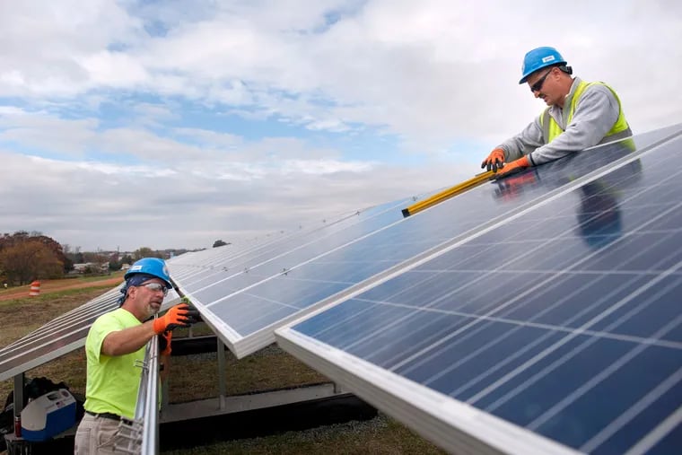 Electricians with Riggs Distler install solar panels for PSE&G at the L&D Landfill solar site in Lumberton in November 2015. Pennsylvania has increased its solar activity since then, but it still lags behind its neighboring states.
