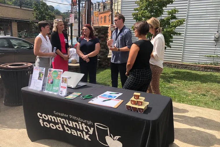 Secretary Teresa Miller, far left, of Pa.'s Department of Human Services stops at a Pittsburgh food bank for her Hunger Action Month tour, visiting organizations and volunteers across the state who are fighting food insecurity.