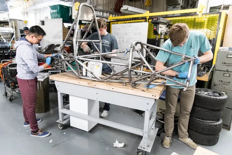 University of Pennsylvania students sand the frame of their electric race car, which they project will go zero to 60 miles an hour in less than 2.3 seconds.