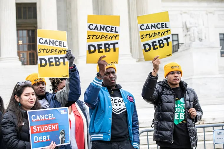 Demonstrators in favor of canceling student debt rally outside the U.S. Supreme Court Tuesday as the justices heard arguments in two cases dealing with the Biden administration's student loan forgiveness plan.