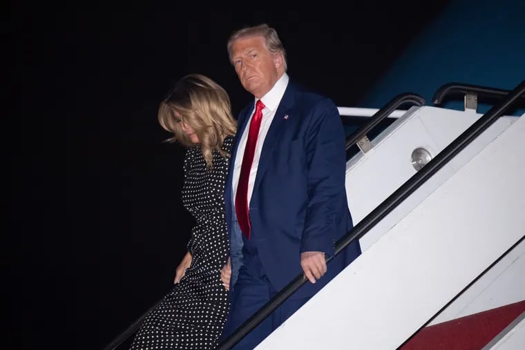 President Donald Trump and first lady Melania Trump disembarking from Air Force One at Palm Beach International Airport in Florida on Dec. 23.