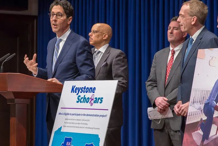 State Treasurer Joe Torsella and supportive lawmakers (including Philly Sen. Vince Hughes, behind Torsella), at a recent Harrisburg news conference announce the start of a program to help kids save for education.
