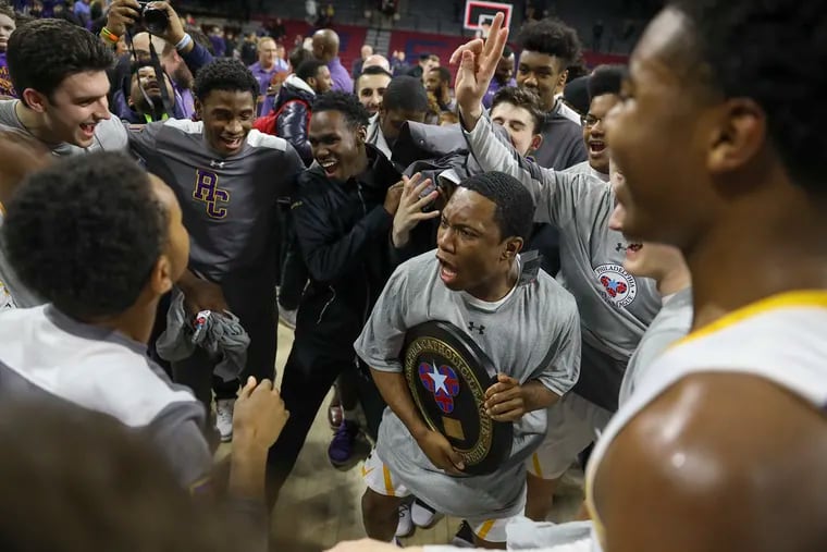 The Roman Catholic boys' basketball team celebrates after beating La Salle, 64-50, at the Palestra on Monday for the Catholic League championship.