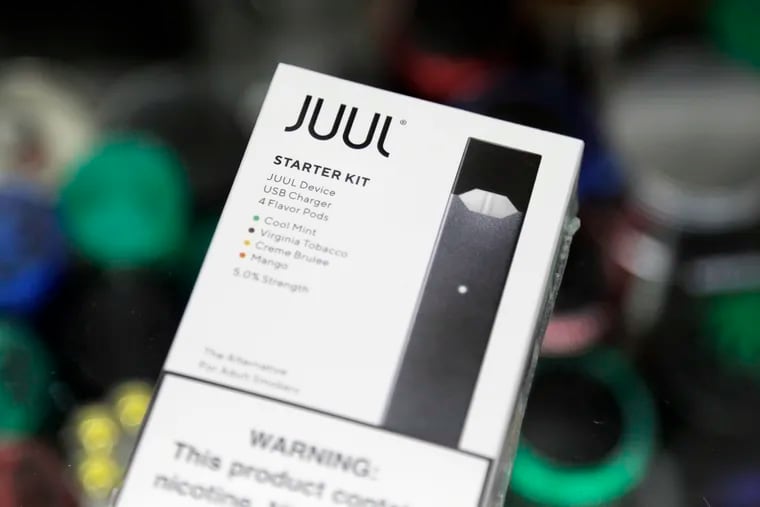 This Thursday, Dec. 20, 2018 file photo shows a Juul electronic cigarette starter kit at a smoke shop in New York.  (AP Photo/Seth Wenig)