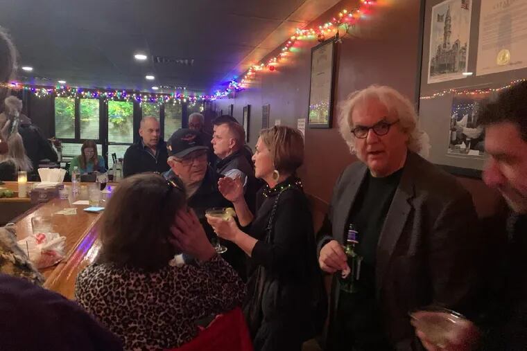 Stephen Fried (on the right), a Philadelphia author and professor at the University of Pennsylvania, threw his annual party Thursday at the Pen & Pencil Club. The venue checked vaccination cards at the door for entry.