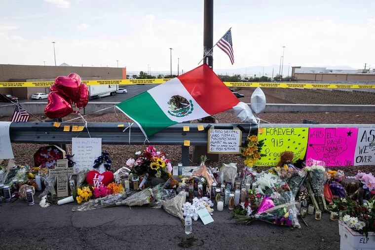 Flowers, flags, stuffed animals, candles and posters honor the victims of the Aug. 3, 2019 mass shooting at a Walmart in El Paso.