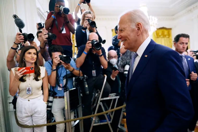 President Joe Biden walks past reporters and photographers as he departs the East Room at the White House in August.