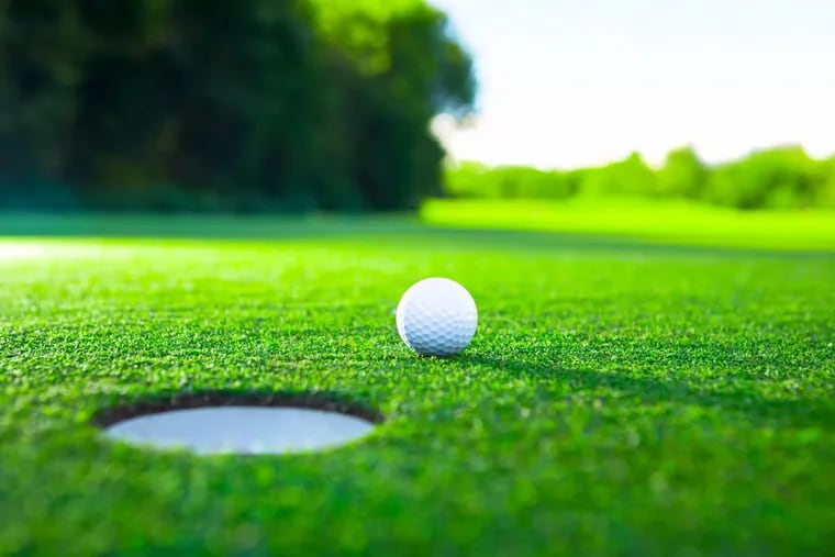 Golf ball on the green. Stock photo