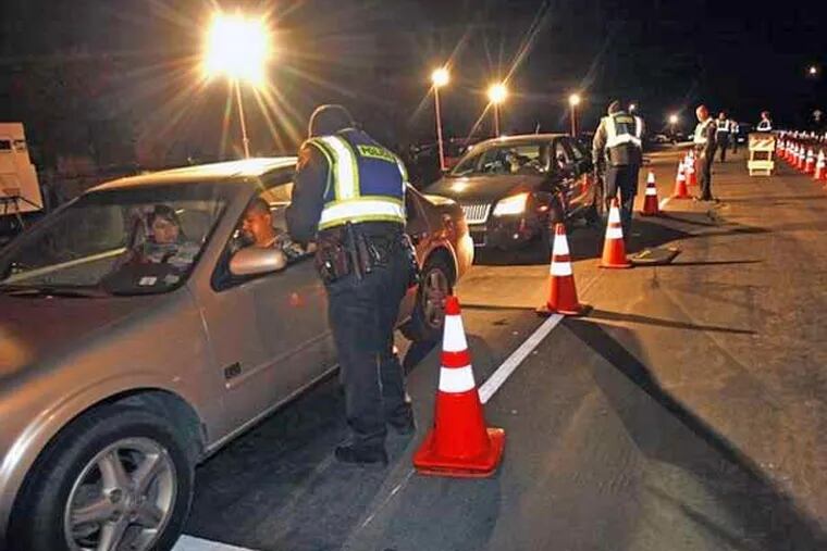 Drivers line up at a DUI checkpoint. (AP file photo)