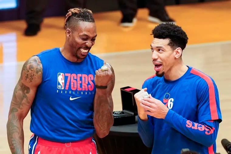 76ers center Dwight Howard and forward Danny Green wear their Lakers championship rings that they received before Thursday's game against Los Angeles.