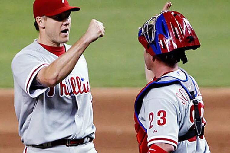 Jonathan Papelbon and Brian Schneider celebrate after the final out. (Wilfredo Lee/AP)