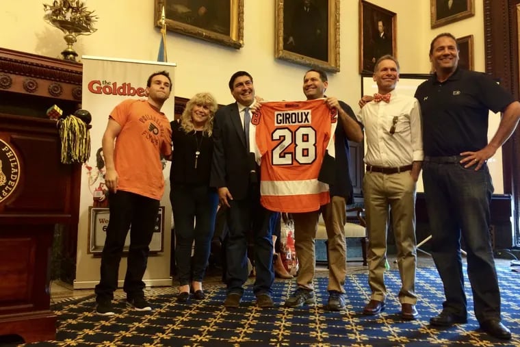 Troy Gentile, the real Beverly Goldberg, Adam F. Goldberg, the real Barry Goldberg, Eric Goldberg and Ike Richman, VP of public relations at Comcast-Spectator and Adam’s old hockey coach, at City Hall ceremony Friday.