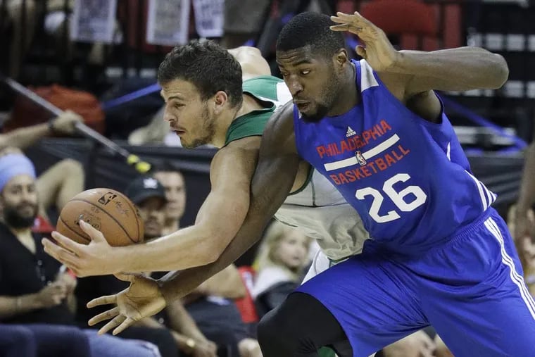 Mathias Lessort (right) of the Sixers chases a loose ball with Boston’s Ante Zizic.