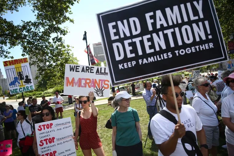 People gather for a protest against the Trump administration's separation and detention of immigrant families at Logan Square in Philadelphia on Saturday, June 30, 2018. Similar protests were held elsewhere across the country Saturday.