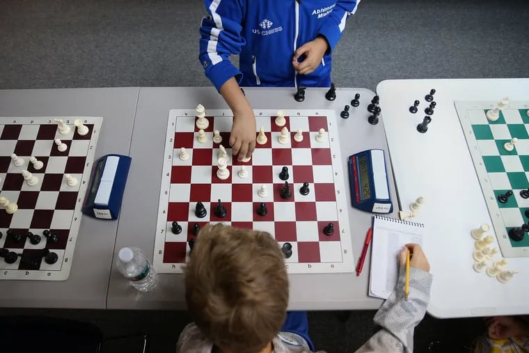 Abhimanyu Mishra, 9, of Englishtown, N.J., top, plays a move against Aleksey Sergeev, 12, of Edison, N.J., during a simultaneous exhibition match at Kings and Queens Chess Academy in Piscataway, N.J., on Saturday, July 28, 2018. Abhi became the youngest ever U.S. chess master in April. TIM TAI / Staff Photographer