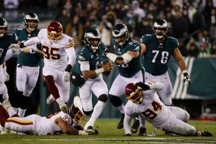 Philadelphia Eagles quarterback Jalen Hurts (1) dodges the Washington Football Team defense and carries for an Eagles first down in the third quarter Tuesday, December 21, 2021 at Lincoln Financial Field in Philadelphia, Pa.