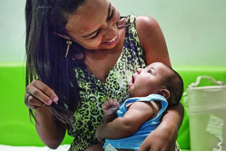 Amanda dos Santos , 19, with son Emanuel, 3 months, who was born with microcephaly in Brazil. She thinks she had the Zika virus early in her pregnancy. KATIE FALKENBERG / Los Angeles Times