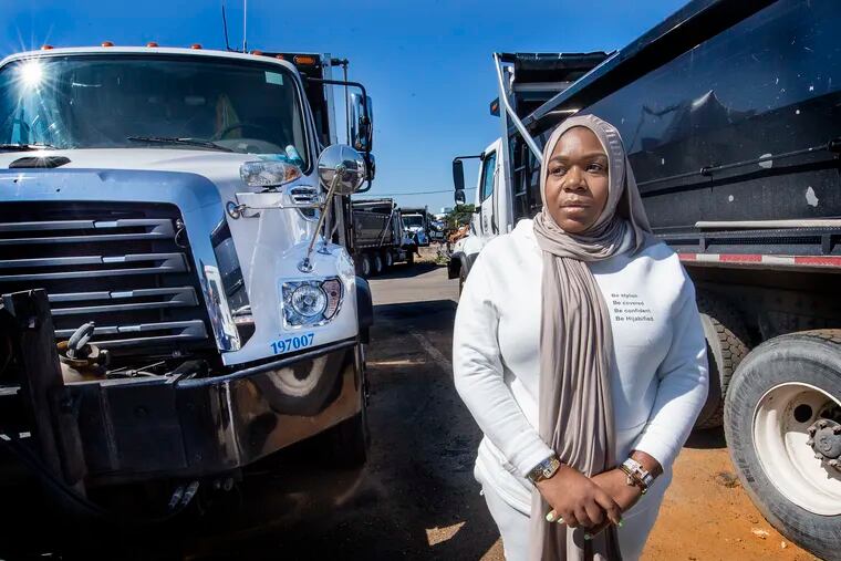 Niddarah Winters next to her tipper truck in Philadelphia last month. Winters used the money she earned driving a truck for the Philadelphia Streets Department to start a clothing line for Muslim women.