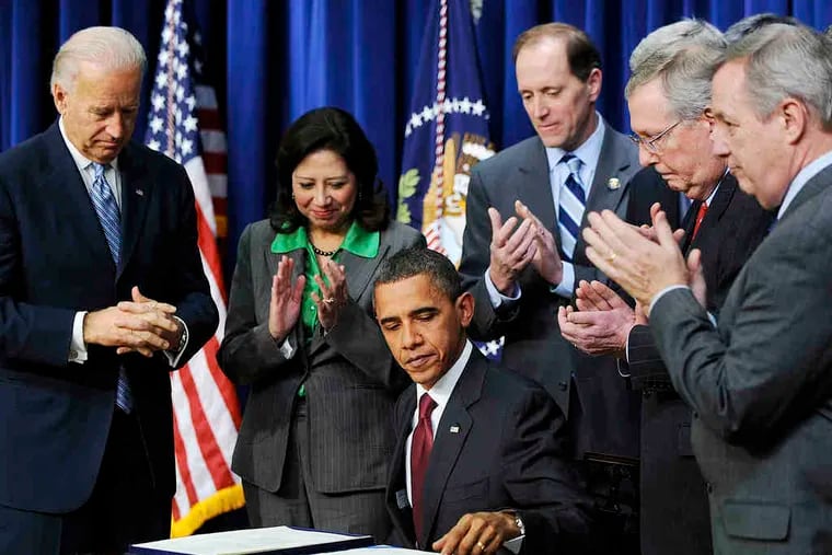 President Obama signs into law the tax bill that, among other things, extends for two years cuts that were set to expire at year's end. Senate Republican Leader Mitch McConnell (second from right) and others watched the culmination of a hard-fought deal. A2. What the law means for you: A13.