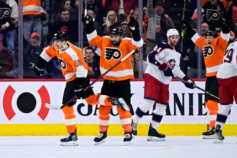 The Flyers' Noah Cates, left, celebrates after scoring against the Columbus Blue Jackets during the first period Tuesday night.
