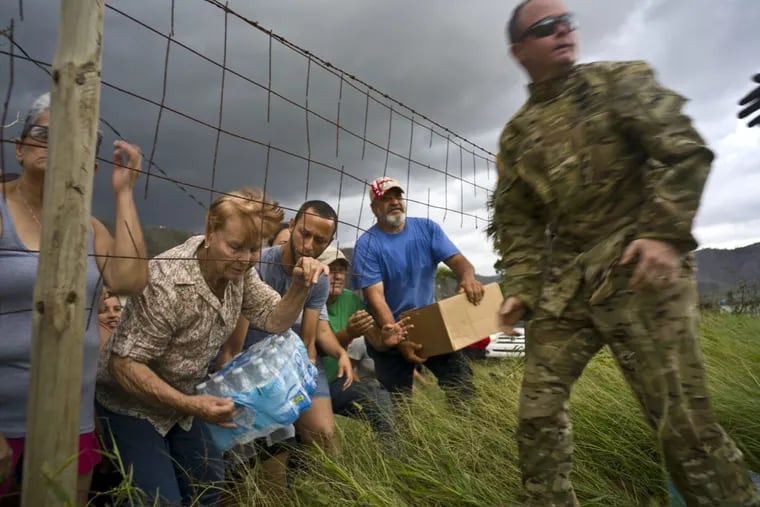 Puerto Rican National Guard delivers food and water, brought via helicopter, to residents of Morovis, Puerto Rico, on Oct. 7.