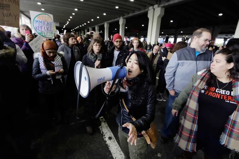 Councilwoman Helen Gym speaks at a protest at Philadelphia International Airport.